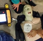 Defibrillator set up instructing us when to do compressions and when to stand clear and SHOCK